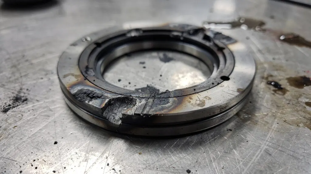 Damaged mechanical seal from a centrifugal pump showing severe scoring and dry-run damage